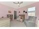Charming bedroom with a crib, armchair, and decorative accents at 5755 Woodland Sage Dr, Sarasota, FL 34238