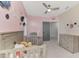 Pastel Bedroom features a crib, chair, and dresser at 5755 Woodland Sage Dr, Sarasota, FL 34238