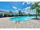 Expansive kidney shaped community pool with a clubhouse at 5755 Woodland Sage Dr, Sarasota, FL 34238