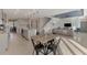 Bright dining area with wooden table and black metal chairs near kitchen at 5755 Woodland Sage Dr, Sarasota, FL 34238