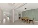 Dining area with wooden table and chairs, view into living room at 5755 Woodland Sage Dr, Sarasota, FL 34238