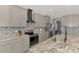Modern kitchen with gray cabinets, granite countertops, and stainless steel appliances at 5755 Woodland Sage Dr, Sarasota, FL 34238