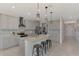 Modern kitchen with gray cabinets, granite countertops, and island at 5755 Woodland Sage Dr, Sarasota, FL 34238