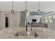 Kitchen island with sink, granite countertop and modern faucet at 5755 Woodland Sage Dr, Sarasota, FL 34238