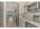 Kitchen with gray cabinets, granite countertops and built in coffee maker at 5755 Woodland Sage Dr, Sarasota, FL 34238