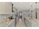 Open concept kitchen boasting granite countertops and stainless steel appliances at 5755 Woodland Sage Dr, Sarasota, FL 34238