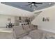 Open living room with view into kitchen and neutral color palette at 5755 Woodland Sage Dr, Sarasota, FL 34238