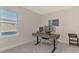 Home office with standing desk, two monitors, and printer at 5755 Woodland Sage Dr, Sarasota, FL 34238