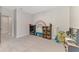 Playroom with rainbow wall art, toy storage, and gray carpeting at 5755 Woodland Sage Dr, Sarasota, FL 34238