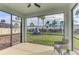Relaxing screened patio overlooking a backyard with playground at 5755 Woodland Sage Dr, Sarasota, FL 34238