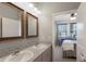 Bathroom with double vanity and a view into bedroom at 5817 Hevena Ct, Palmetto, FL 34221
