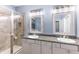 Elegant bathroom with double sinks, granite countertops, and a large shower at 5817 Hevena Ct, Palmetto, FL 34221