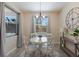Bright breakfast nook with white table and chairs, offering a charming space for dining at 5817 Hevena Ct, Palmetto, FL 34221