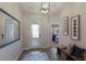 Bright and airy entryway with tiled floor and bench at 5817 Hevena Ct, Palmetto, FL 34221