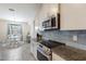 Modern kitchen boasts granite countertops and stainless steel appliances at 5817 Hevena Ct, Palmetto, FL 34221