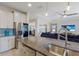 Modern kitchen with stainless steel appliances and granite island at 5817 Hevena Ct, Palmetto, FL 34221