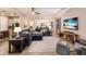 Spacious living area featuring sectional sofa and large TV at 5817 Hevena Ct, Palmetto, FL 34221