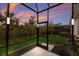 Screened patio provides access to backyard and features evening lighting at 5817 Hevena Ct, Palmetto, FL 34221