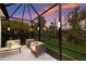 Relaxing screened patio with comfy seating, perfect for outdoor enjoyment at 5817 Hevena Ct, Palmetto, FL 34221