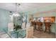 Elegant dining room features a glass table and chandelier at 610 Estuary Dr # 610, Bradenton, FL 34209