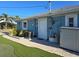 Home's side view showing exterior storage and landscaping at 618 Jungle Queen Way, Longboat Key, FL 34228