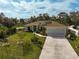 Aerial view of a house with solar panels and a landscaped front yard at 6697 Beckwith Ave, North Port, FL 34291