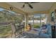 Bright screened porch, featuring seating and a ceiling fan at 6697 Beckwith Ave, North Port, FL 34291