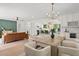 Open concept dining area with light wood table and modern chandelier at 710 31St N Ave, St Petersburg, FL 33704