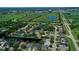 Aerial view of a residential community with houses, canals, and lush green areas at 7596 Palmer Glen Cir, Sarasota, FL 34240