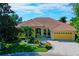 Stunning aerial view of a yellow home with a red tile roof at 7596 Palmer Glen Cir, Sarasota, FL 34240