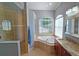 Elegant bathroom with soaking tub, walk-in shower, and granite vanity at 7596 Palmer Glen Cir, Sarasota, FL 34240