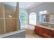 Spa-like bathroom with soaking tub, walk-in shower, and dual sinks at 7596 Palmer Glen Cir, Sarasota, FL 34240