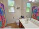 Bright bathroom with shower, vanity, and patterned shower curtain at 7596 Palmer Glen Cir, Sarasota, FL 34240