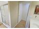 Bathroom with shower, tiled floors, and access to another room at 7596 Palmer Glen Cir, Sarasota, FL 34240