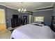 Primary bedroom with large bed, dresser, and backyard view at 7596 Palmer Glen Cir, Sarasota, FL 34240