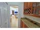Butlers pantry with granite countertop and wine rack at 7596 Palmer Glen Cir, Sarasota, FL 34240