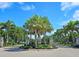 Gated community entrance with lush landscaping and palm trees at 7596 Palmer Glen Cir, Sarasota, FL 34240