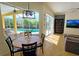 Dining area with round table, pool view, and sliding glass doors at 7596 Palmer Glen Cir, Sarasota, FL 34240