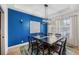 Elegant dining room with a large table and blue accent wall at 7596 Palmer Glen Cir, Sarasota, FL 34240