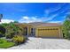 Front view of a yellow house with a paved driveway at 7596 Palmer Glen Cir, Sarasota, FL 34240