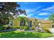 Single-story house with a tile roof, landscaping, and a two-car garage at 7596 Palmer Glen Cir, Sarasota, FL 34240