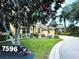Landscaped home with a paved driveway and mailbox at 7596 Palmer Glen Cir, Sarasota, FL 34240