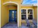 Front entrance with a blue door and a covered entryway at 7596 Palmer Glen Cir, Sarasota, FL 34240