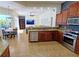 Open concept kitchen with stainless steel appliances and breakfast bar at 7596 Palmer Glen Cir, Sarasota, FL 34240
