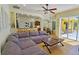 Spacious living room with open floor plan, featuring a large sectional sofa and access to the backyard at 7596 Palmer Glen Cir, Sarasota, FL 34240