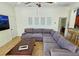 Spacious living room with sectional sofa and large TV at 7596 Palmer Glen Cir, Sarasota, FL 34240