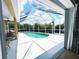 Inviting kidney-shaped pool with screened enclosure at 7596 Palmer Glen Cir, Sarasota, FL 34240