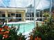 Relaxing pool area with screened enclosure and tropical flowers at 7596 Palmer Glen Cir, Sarasota, FL 34240