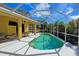 Inviting pool area with screened enclosure, patio furniture, and lush landscaping at 7596 Palmer Glen Cir, Sarasota, FL 34240