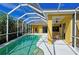 Relaxing pool and patio area with screened enclosure, offering ample space for outdoor enjoyment at 7596 Palmer Glen Cir, Sarasota, FL 34240